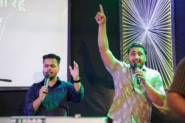 Singers with hands raised