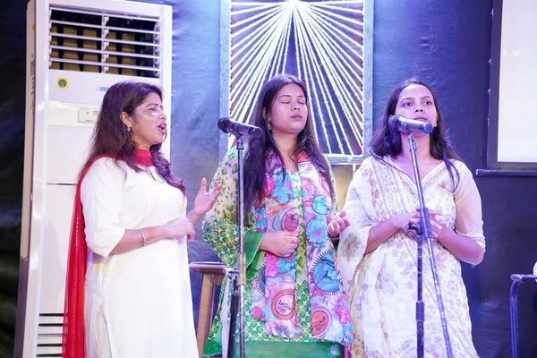 Three women singing together