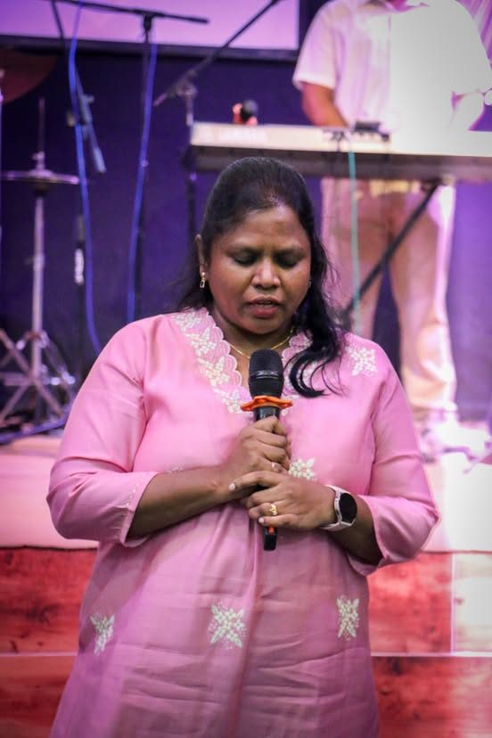 A woman singing with her eyes closed